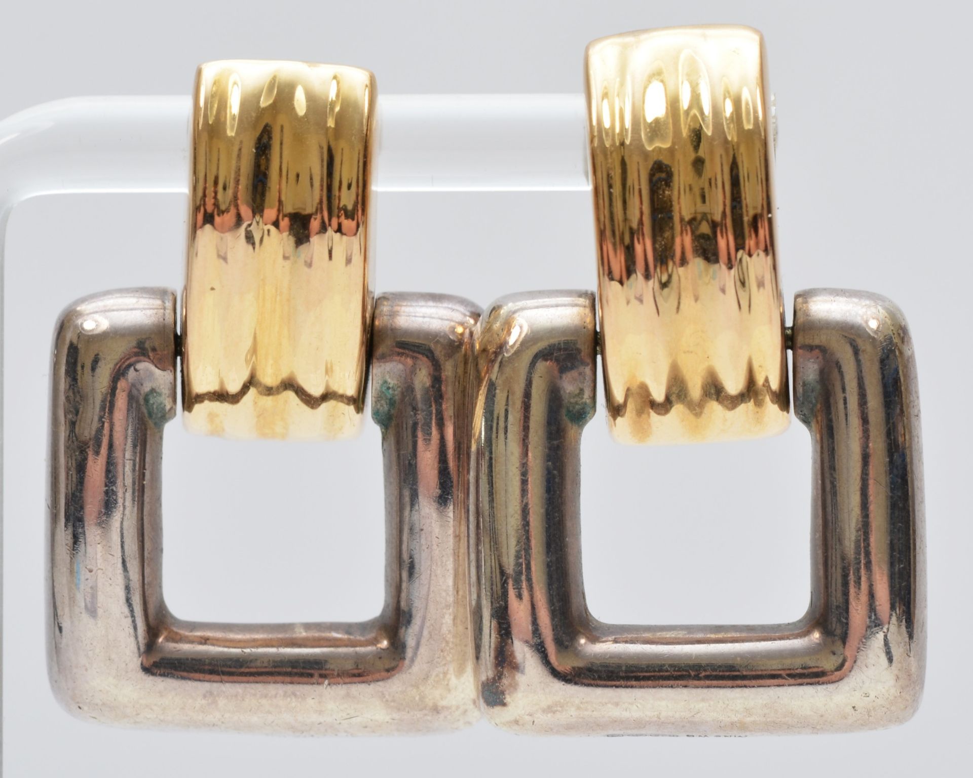 Bayanihan, a 14K gold and silver pair of Modernist ear rings, signed, 35 x 22mm, 11gm. The Bayanihan