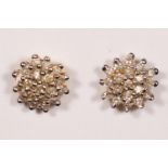 A pair of 18ct gold and diamond cluster ear studs, stated weight 0.28cts, diameter 8mm, 2gm.