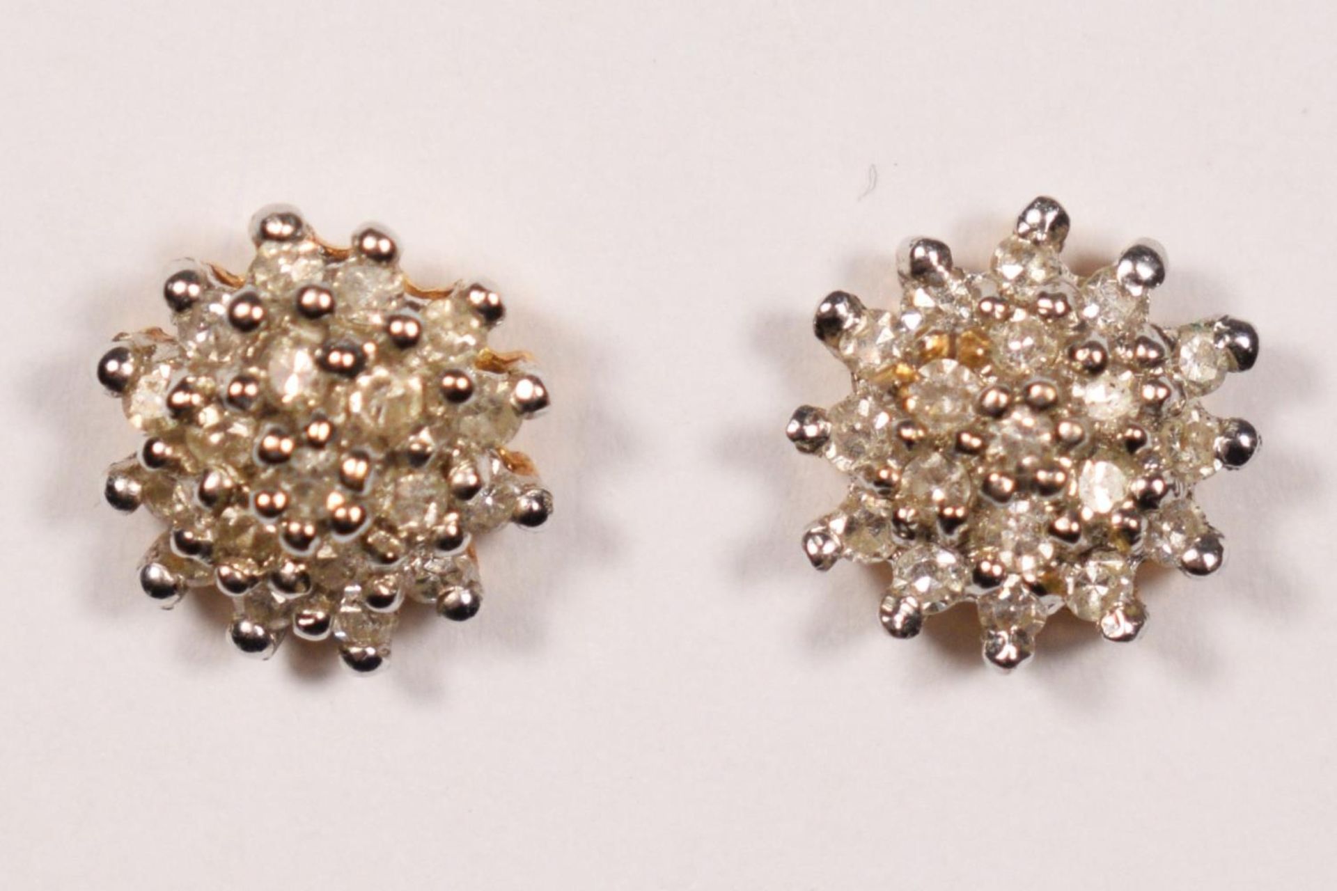 A pair of 18ct gold and diamond cluster ear studs, stated weight 0.28cts, diameter 8mm, 2gm.