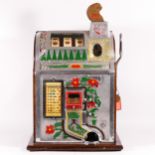 A Mills Poinsettia slot machine, one arm bandit, c.1929, restored and working on a 1D coin, wooden