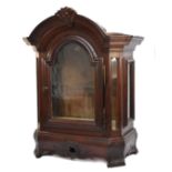 A French oak display cabinet, with arched glazed door, canted glazed panels, raised on a floral