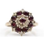 An 18ct white gold ruby and brilliant cut diamond cluster ring, L, 5.6gm