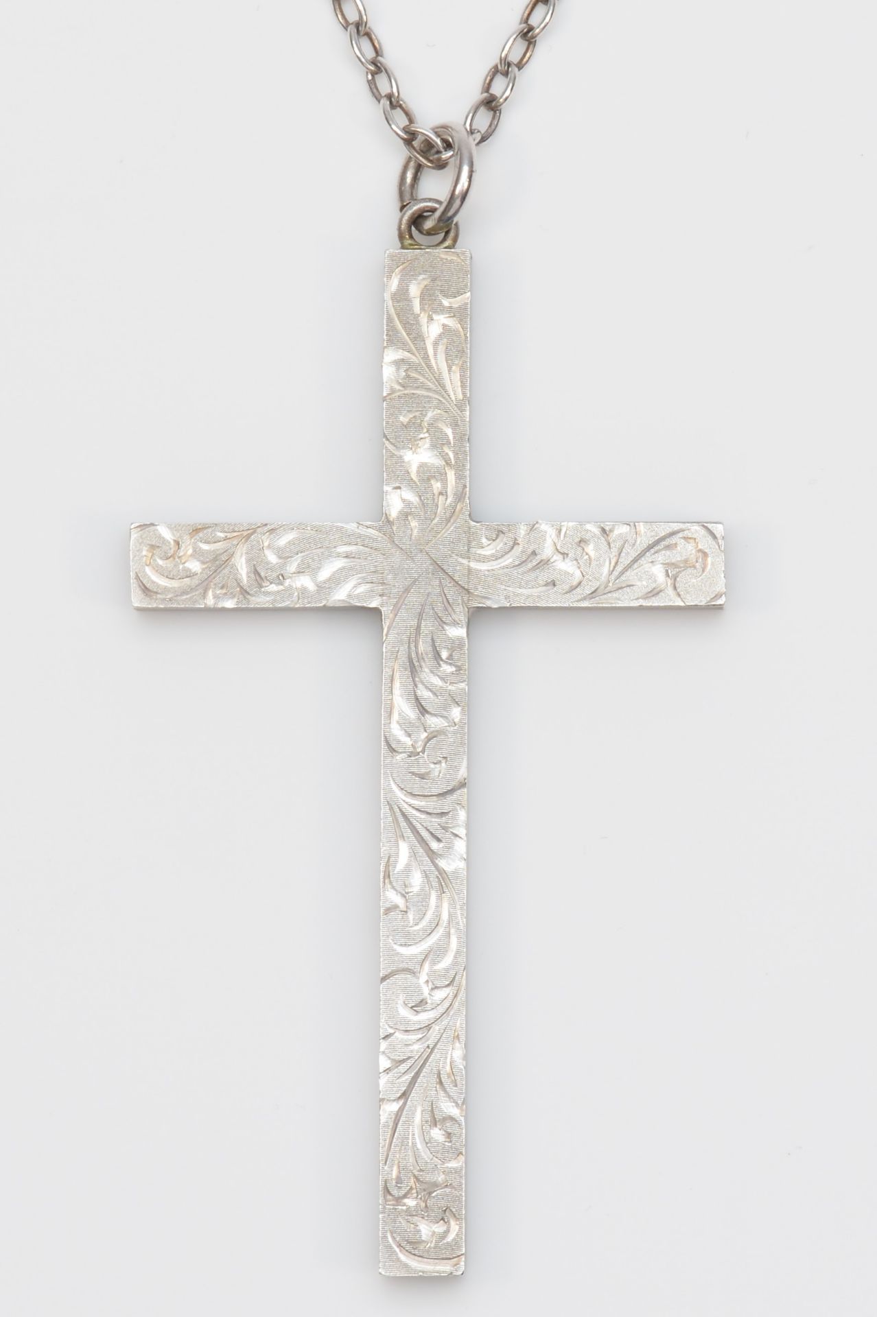 A vintage solid silver cross pendant, Birmingham 1972, with engraved floral decoration, 8 x 4.5cm,