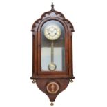 A late 19th century German walnut wall clock, the two part dial with Roman numerals, the case with