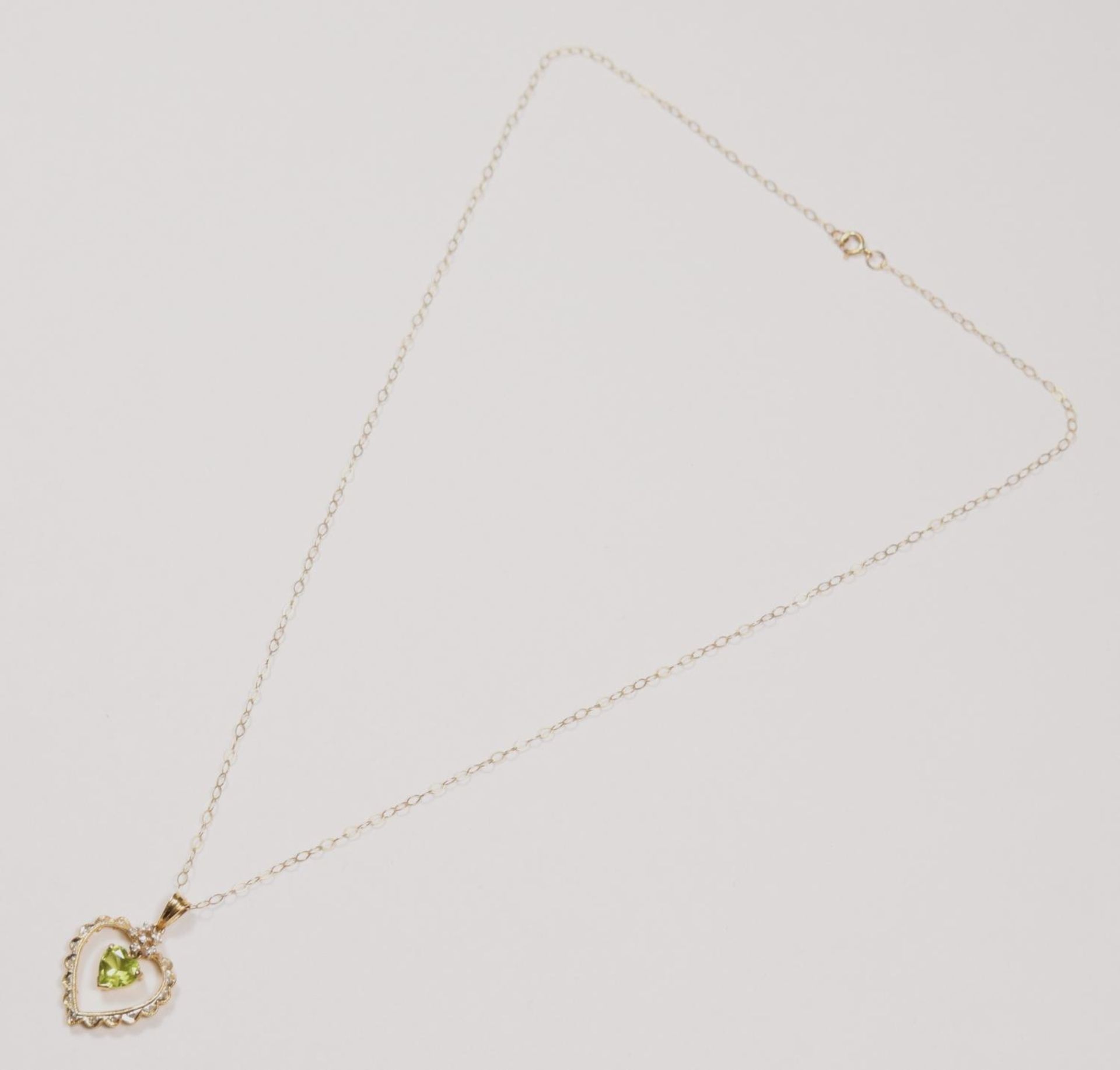 A 14k gold peridot and diamond pendant, claw set with an articulated stone, 24 mm overall, 9ct - Image 2 of 3