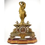 A 19th century French gilt metal mantel clock, the dial with applied white enamel Roman numerals,