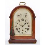 An early 20th century German arched mahogany mantel clock, the silvered dial with subsidiary slow/