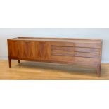 A Danish rosewood sideboard, c.1960s, of long low form with plain top over two banks of three