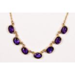 A Victorian style 9ct gold and amethyst necklace, Birmingham 1967, collet set with seven mixed cut