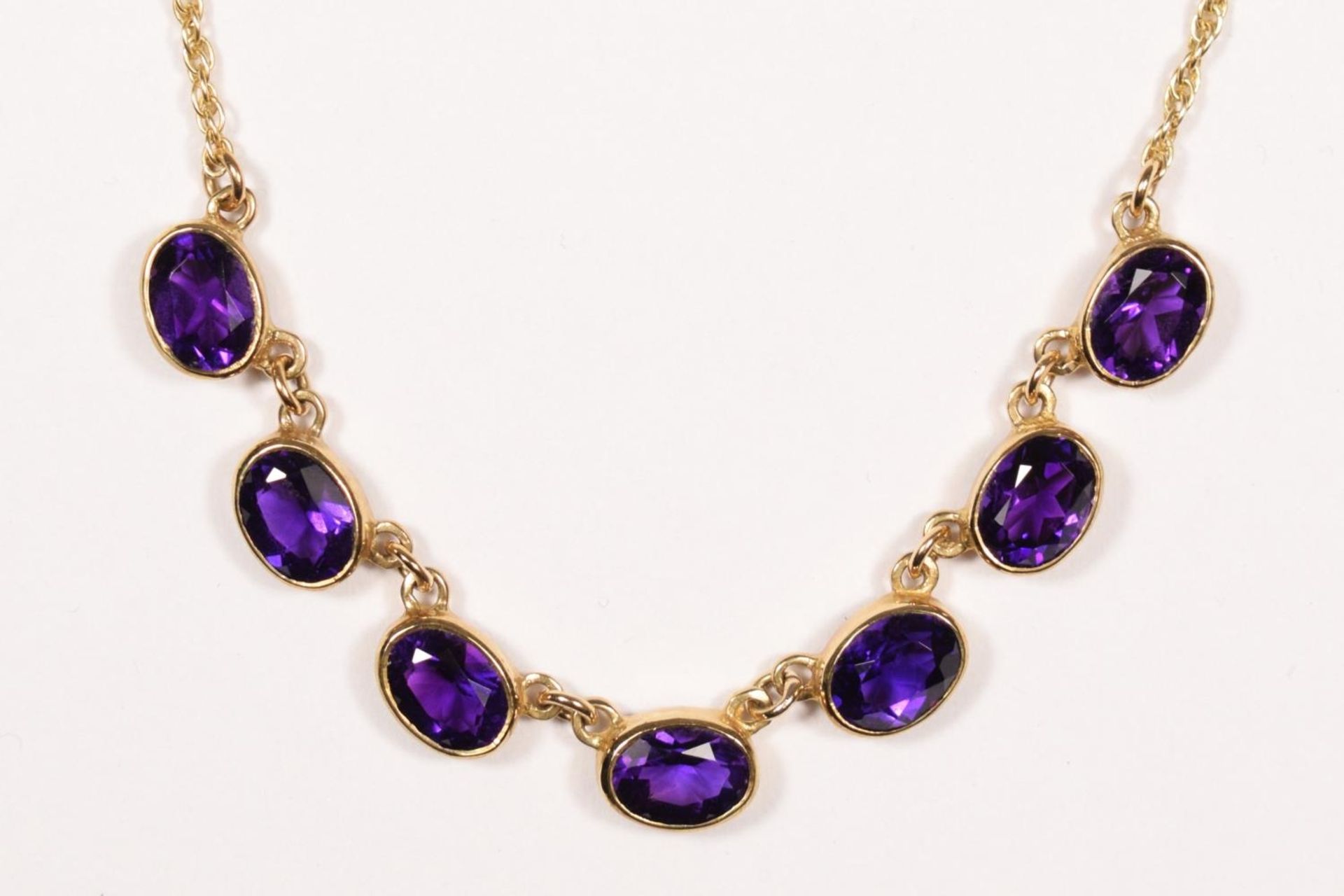 A Victorian style 9ct gold and amethyst necklace, Birmingham 1967, collet set with seven mixed cut