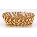 An Italian 18ct gold woven bracelet, stamped 750, with applied decoration,17.5cm, 33.1gm