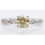 A 14K white gold single stone natural fancy yellow brilliant cut diamond ring, AIG certificate