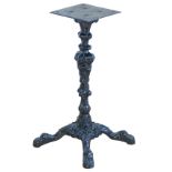 A cast iron slot machine stand, cast floral pedestal on four clawed feet, 66cm tall.