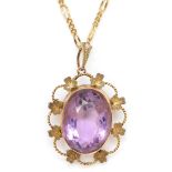 A Victorian oval amethyst brooch/pendant, with floral border, 9c tab, 28 x 22mm, 5.1gm, to a metal