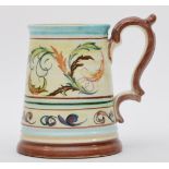 A Denby tapering tankard, with floral scroll decoration, signed to base, 14cm.