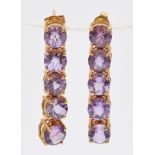 A 9ct gold pair of amethyst drop ear rings, articulated claw set with facetted stones, length