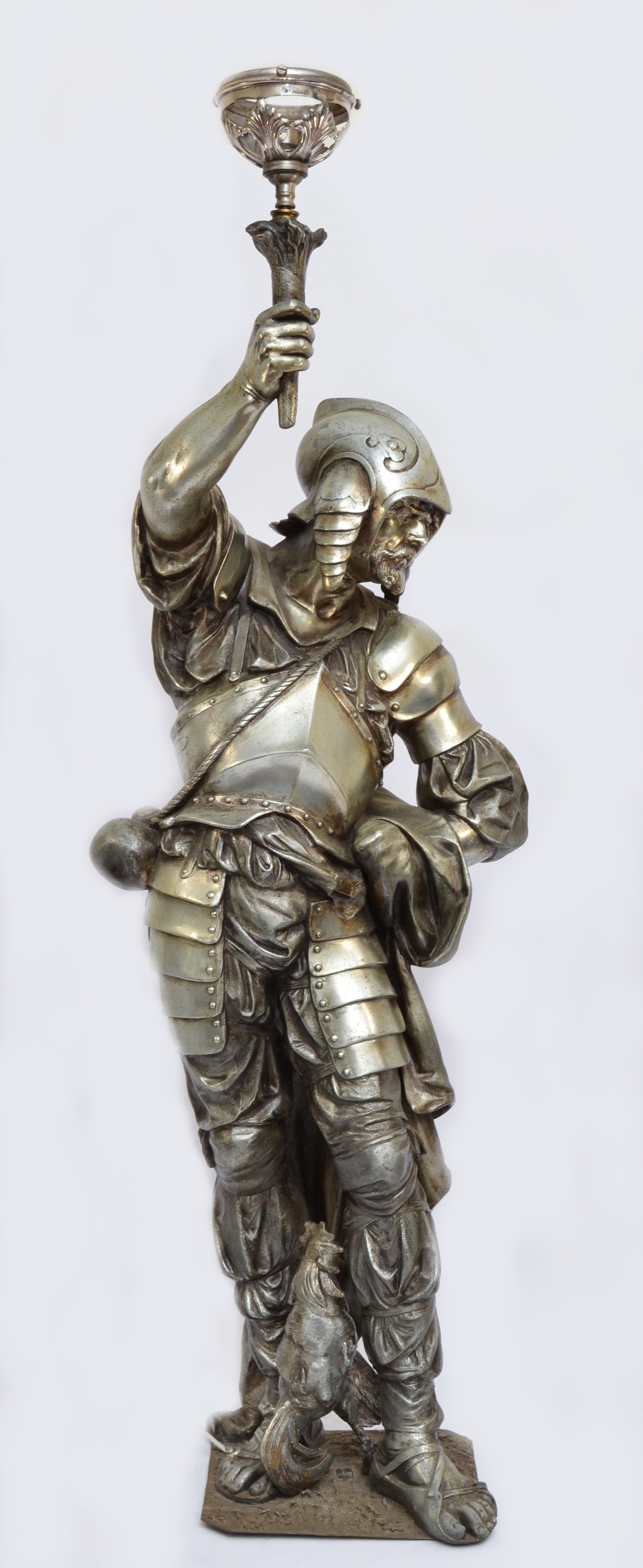 A late 19th/early 20th century French silvered metal figural lamp, in the form of a 16th century