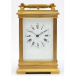 A brass repeating and striking carriage clock, the white enamel dial with Roman numerals, the