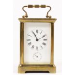 A brass carriage alarm time piece, white enamel dial with Roman numerals and subsidiary alarm