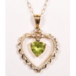 A 14k gold peridot and diamond pendant, claw set with an articulated stone, 24 mm overall, 9ct