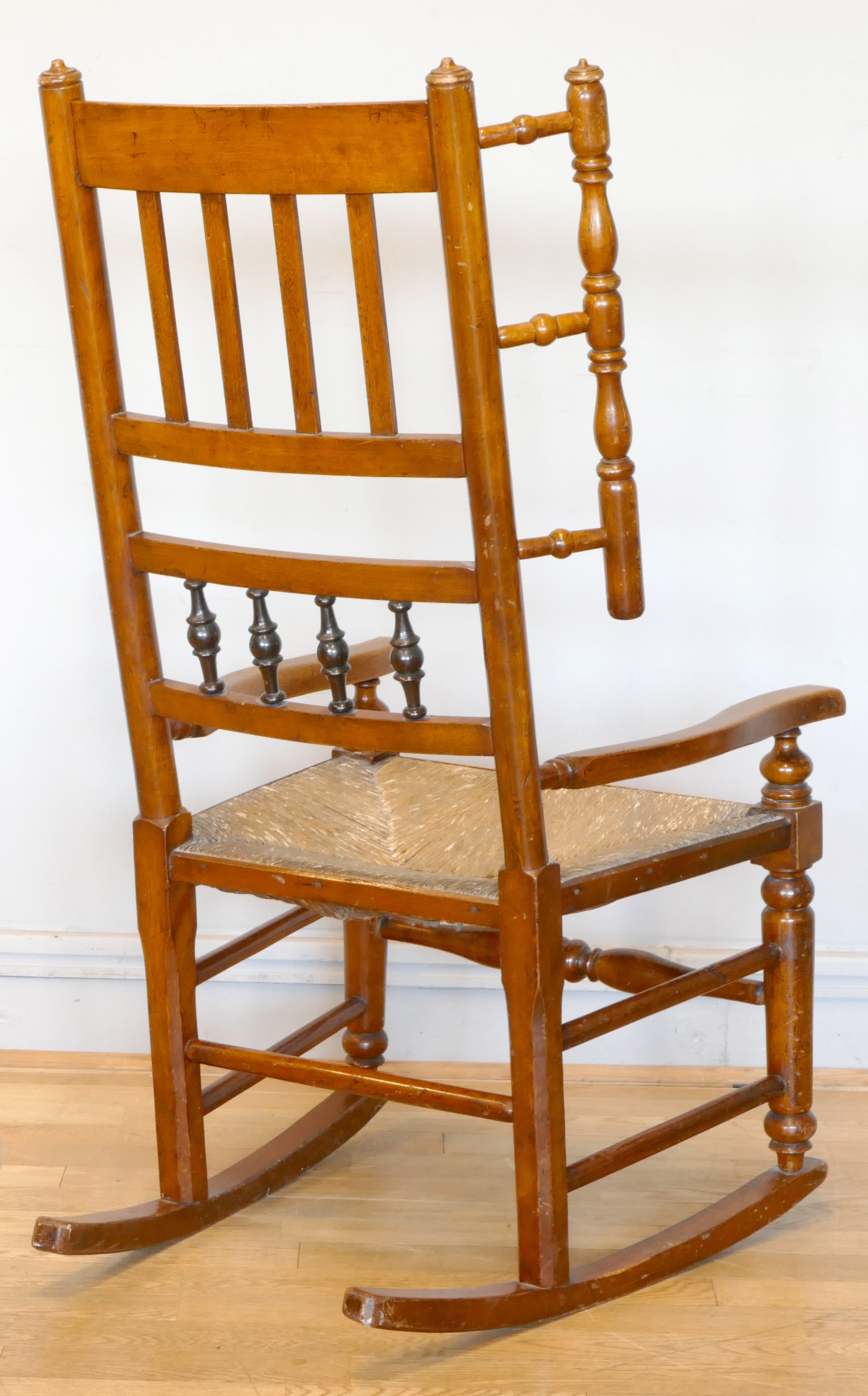 A 19th century Lancashire fruitwood winged rocking chair, having spindle back with rush seat, raised - Image 3 of 5