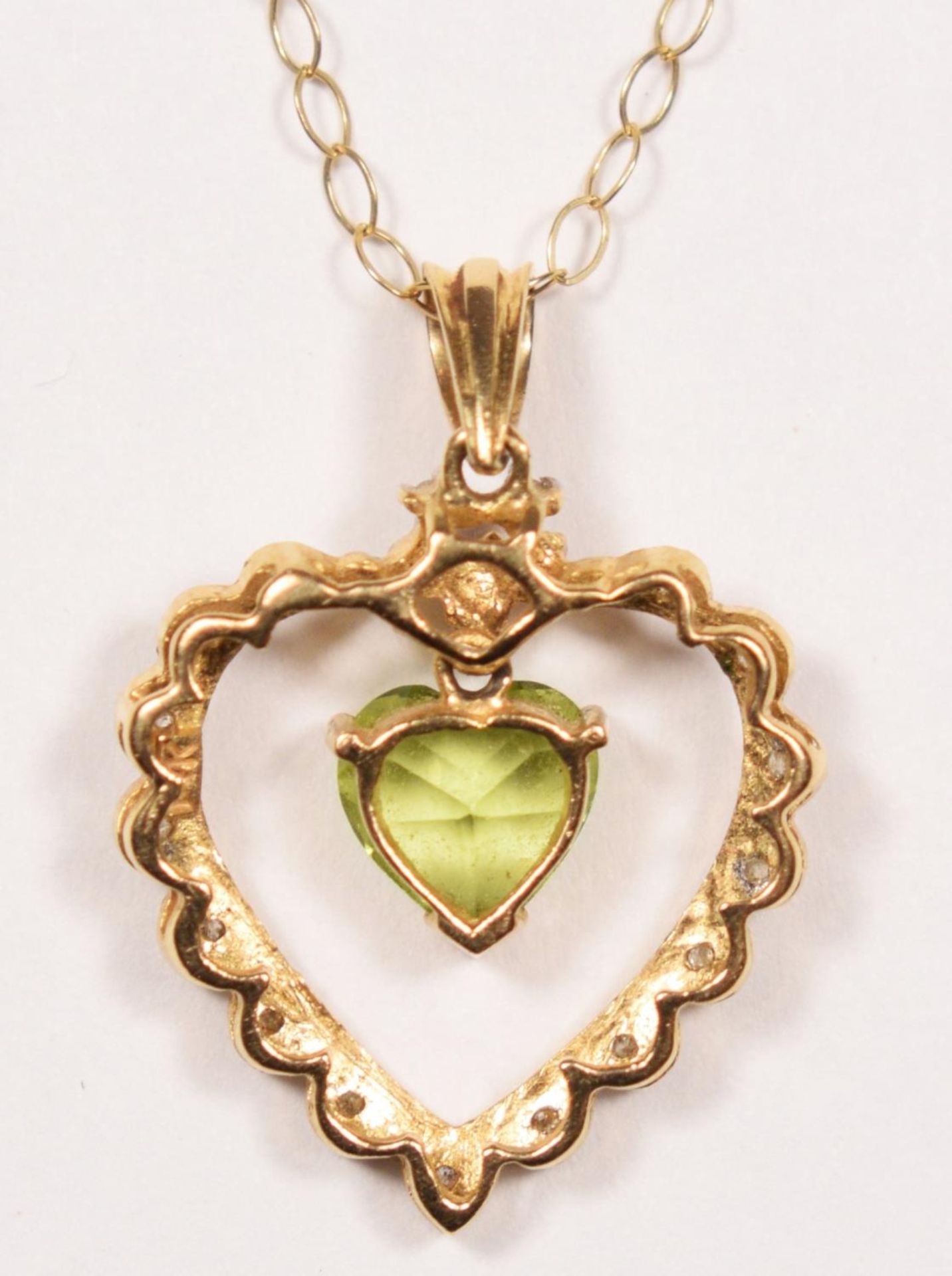 A 14k gold peridot and diamond pendant, claw set with an articulated stone, 24 mm overall, 9ct - Image 3 of 3