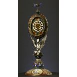 A 19th century Viennese enamel table clock, the oval case containing a pocket watch movement, the