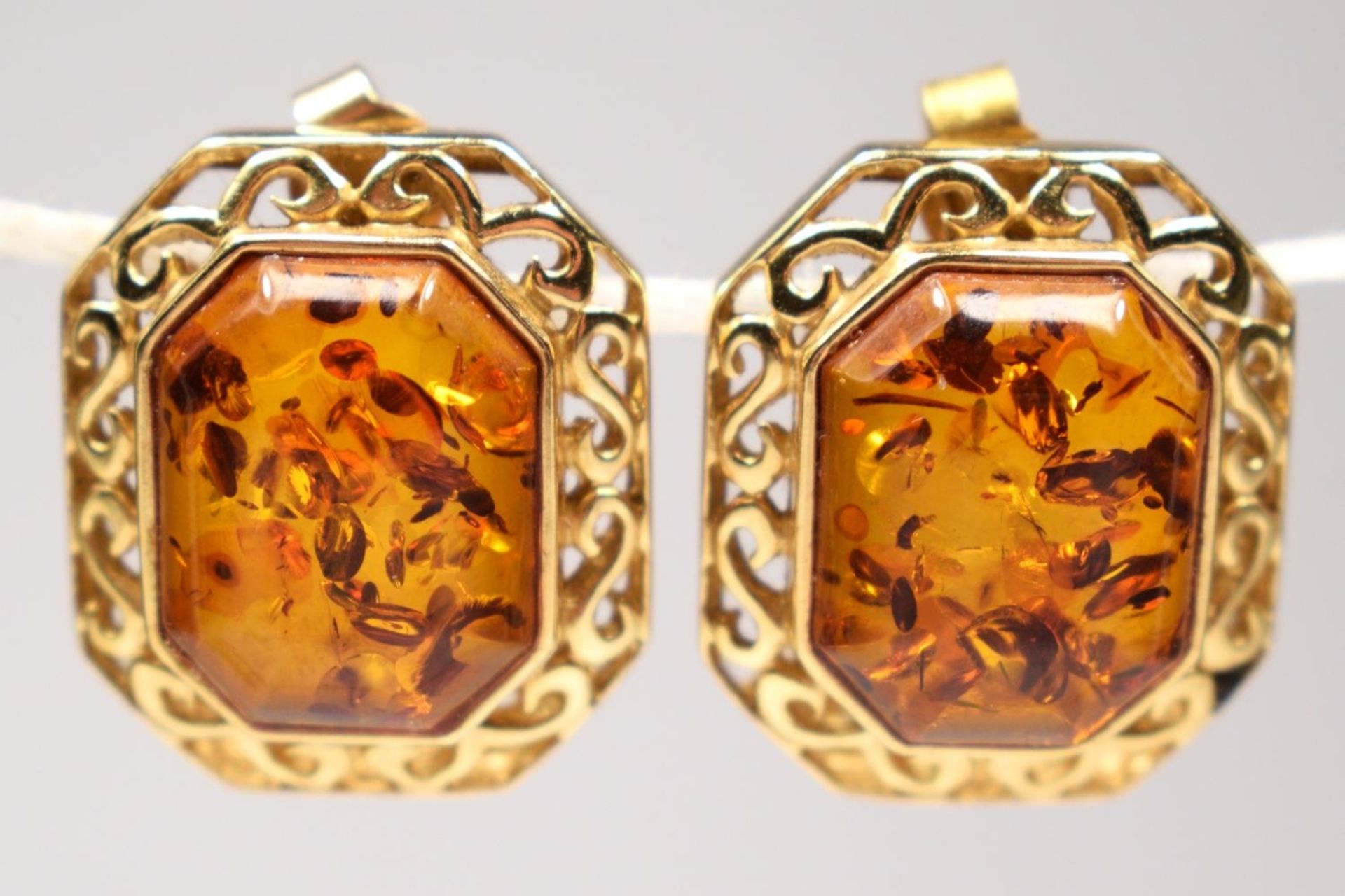 A continental 14k gold and amber pair of ear studs, bearing control marks, 18 x 15cm overall, 5.8gm.