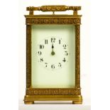 A brass repeating and striking carriage clock, the dial with Arabic numerals, the case with