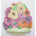 A Beswick wall plaque, c.1930s, depicting flowers, hand painted, stamped on verso 565, 14.5cm.