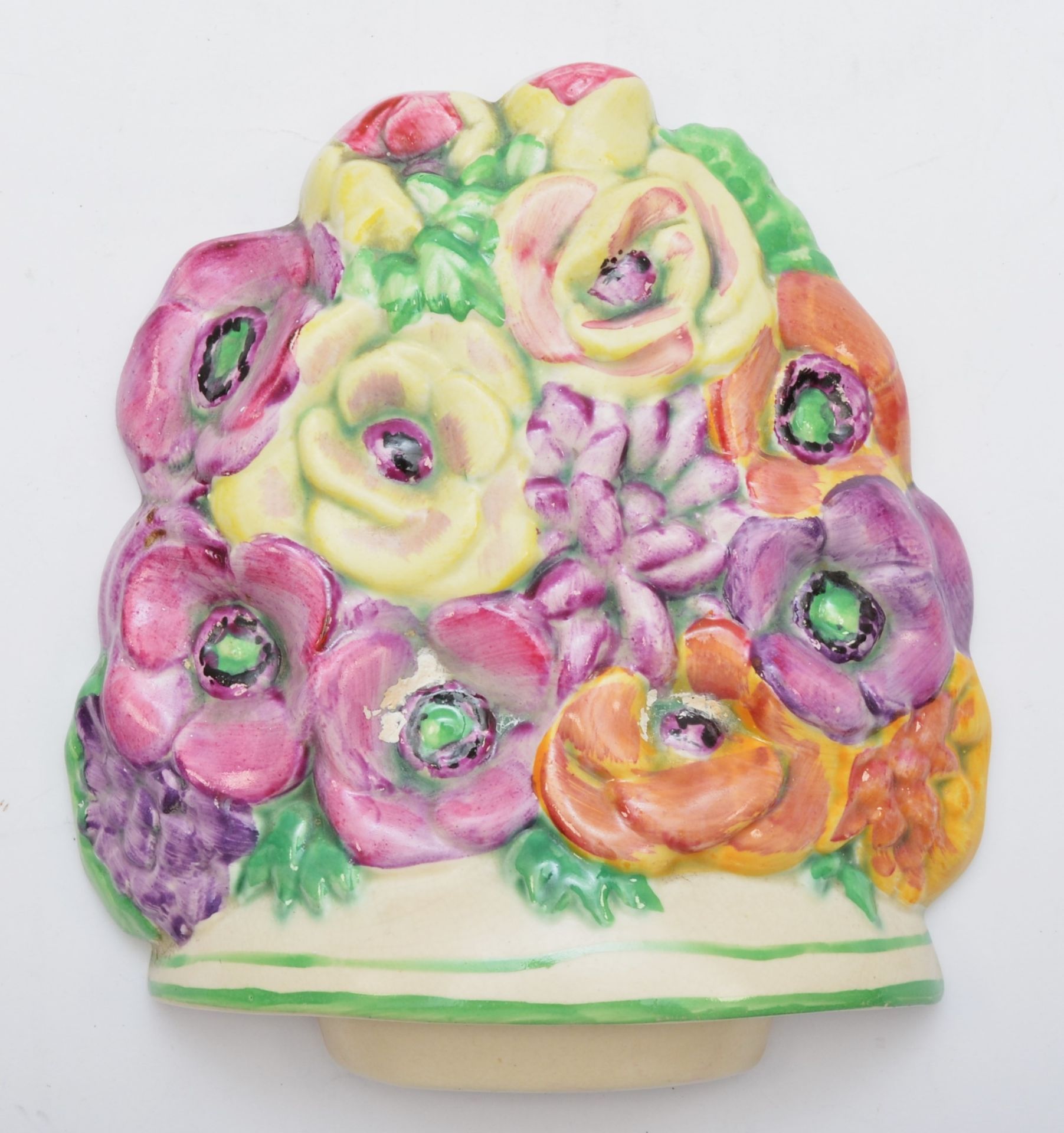 A Beswick wall plaque, c.1930s, depicting flowers, hand painted, stamped on verso 565, 14.5cm.