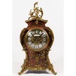 A 19th century French boulle mantel clock, the dial with applied white Roman numerals, the red