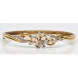 A 9K gold opal and diamond floral spray fronted bracelet, 59 x 50mm internal, 10.8gm