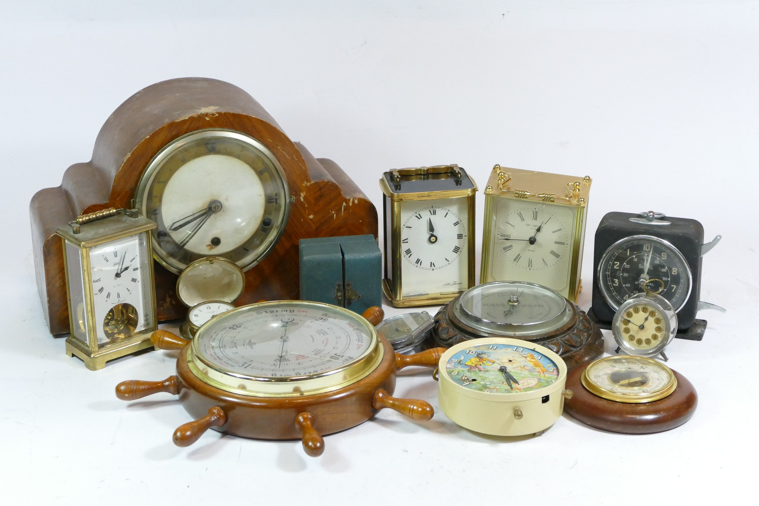 A collection of mid 20th century and later mantel clocks, carriage clocks and barometers, having