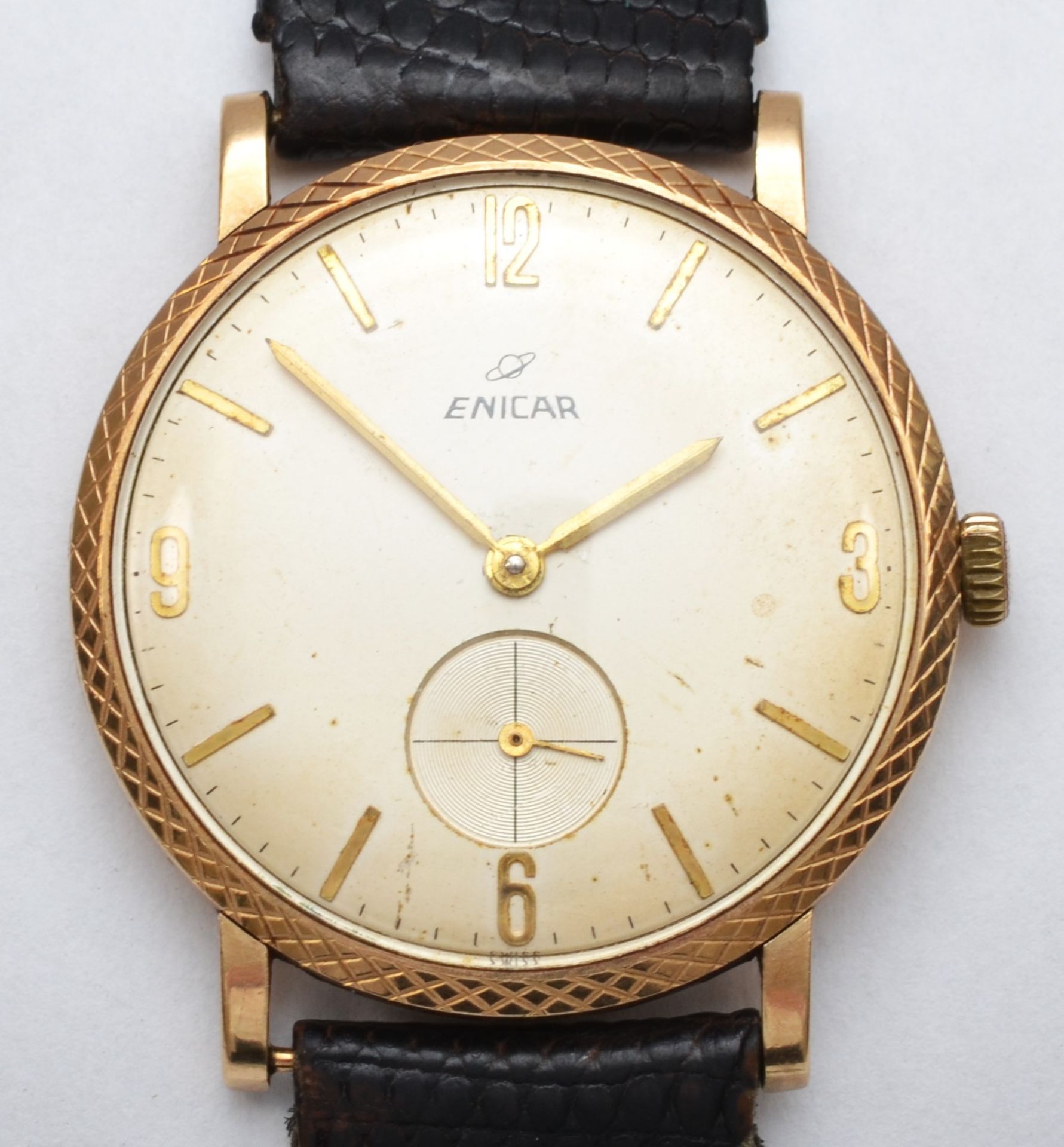 A 9ct gold gents Enicar wrist watch c1960s, having manual wind jewelled movement with black