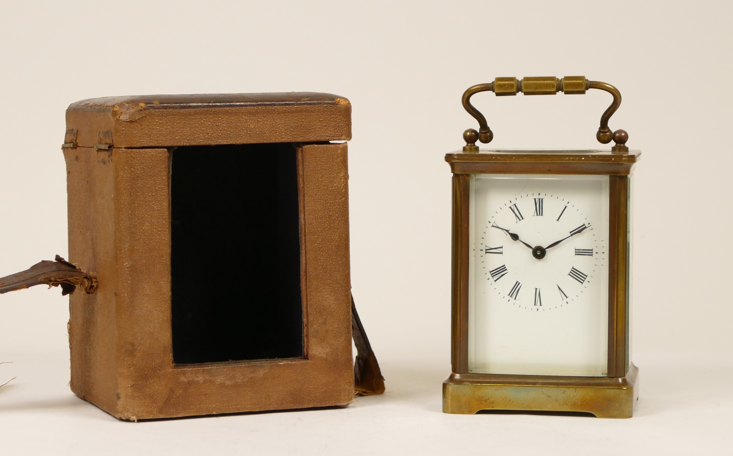 An early 20th century French brass carriage clock, having enamelled dial with Roman numerals,