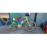 A Emmelle Nemesis push bike, with 6 gears, speedo, headlamp, detachable bag, in graduated neon green