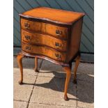 A serpentine fronted set of drawers, three drawers with brass handles, on cabriole legs, 51 x 76 x