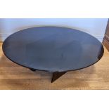 A modern stylised smoked glass occasional/coffee table. 109cm diameter.