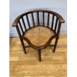 An early 20th century bobbin turned corner chair with cane seat. W57, H63cm.