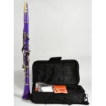 A Slade clarinet, made in the USA, finished in a bright purple colourway, in a case with a fitted