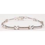 An 18K white gold and diamond set bracelet, three links set with nine brilliant cut stones each,