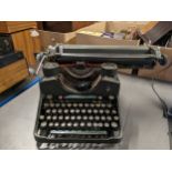 A Bar-Lock type writer, made in Nottingham, together with a collection of portable type writers,