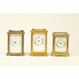 Three mid 20th century brass 8 day carriage clocks, having enamelled dials with Roman numerals,