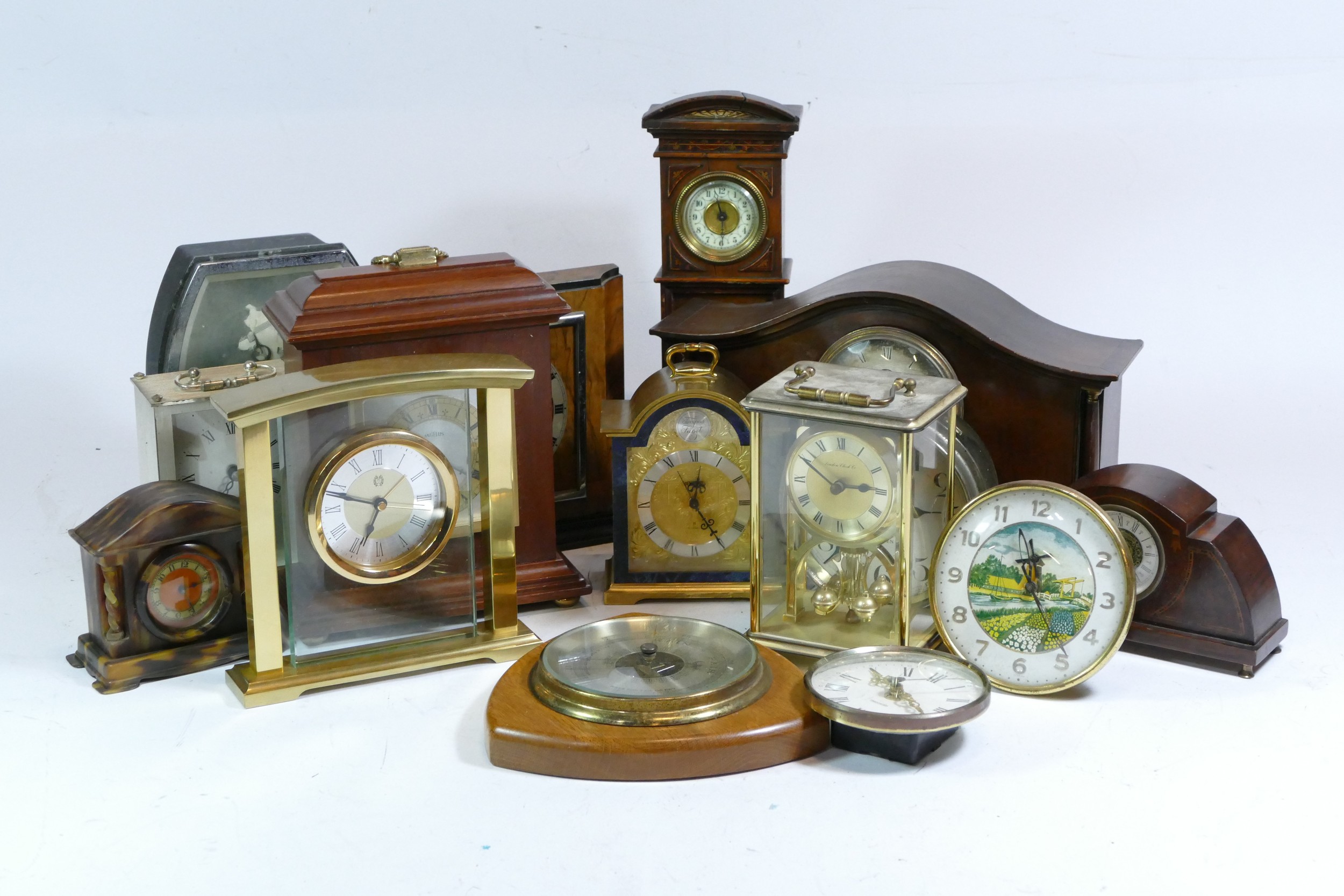 A collection of mid 20th century and later mantel clocks, carriage clocks and barometers, having