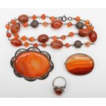 A silver mounted agate necklace, 2 silver and agate brooches and a ring, 100g.