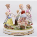 A Neundorf of Germany porcelain figural group `Ring a Ring a Roses`30cm diameter.