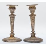 A Victorian pair of silver candlesticks, Birmingham 1900, with embossed ribbon and swag