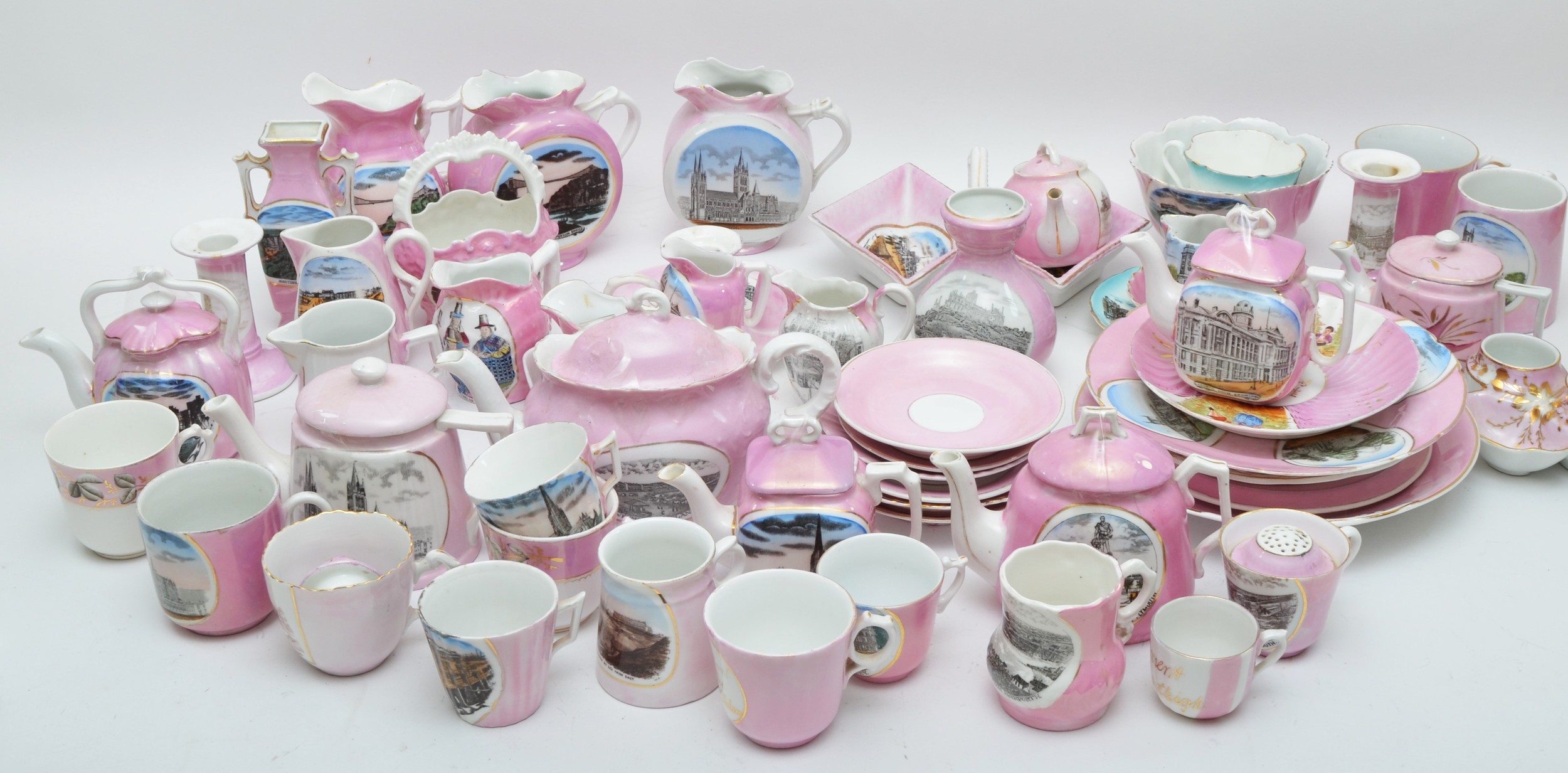 A large collection of early 20th century souvenir lustreware pottery pieces, to include teapots,