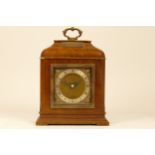 A mahogany cased Elliott mantel clock, having brass dial with silvered chapter ring bearing Roman